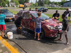 junior high boys washing cars