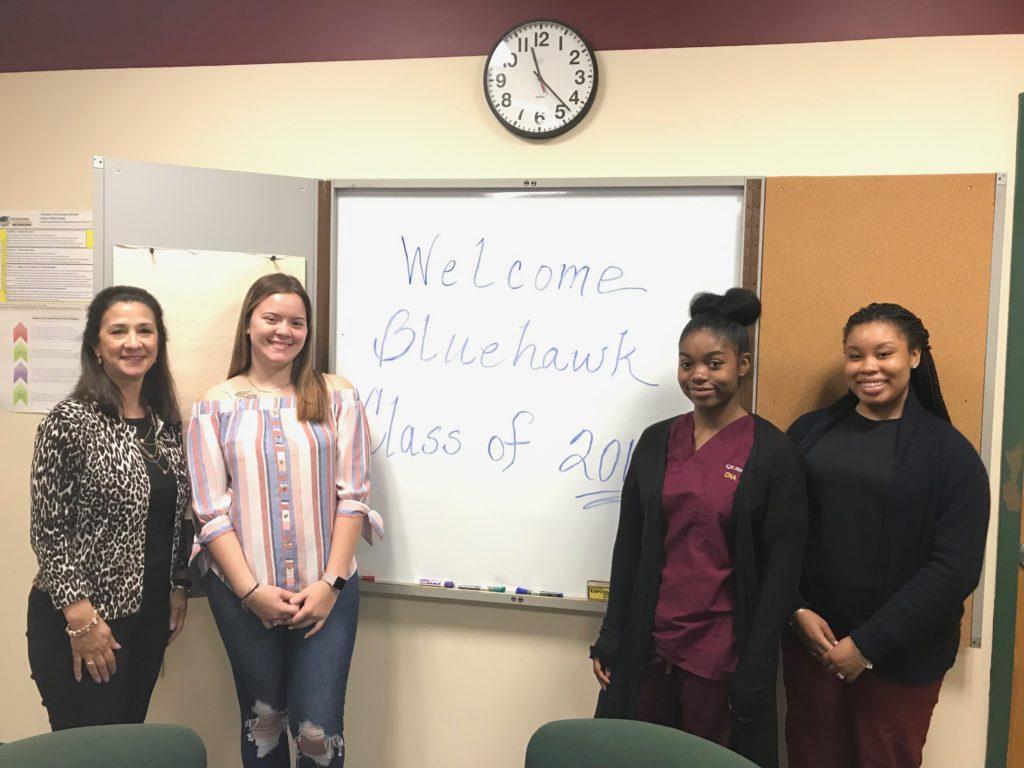 superintendent and three members of the senior class