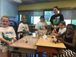 students and teacher at classroom desks