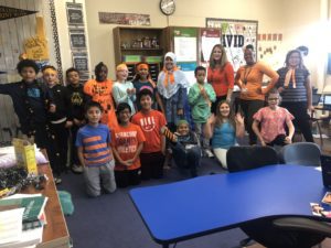 teachers and students wearing orange t-shirts
