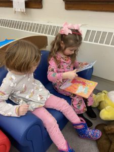 two pre-kindergarten girls read together