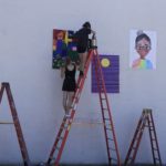 hanging murals on exterior wall