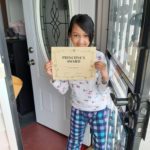 elementary student receives with a certificate