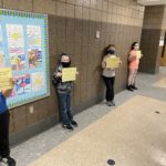 elementary students holding Honesty/Trustworthiness Certificate