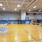 children in gym surrounding a taped off area