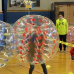 principals do a sumo bubble tournament in the gym