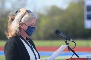 woman speaks at outdoor podium