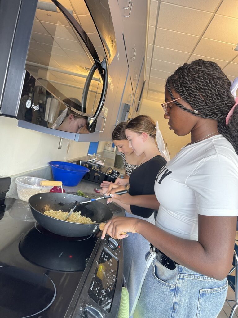 A student cooking mexican street corn